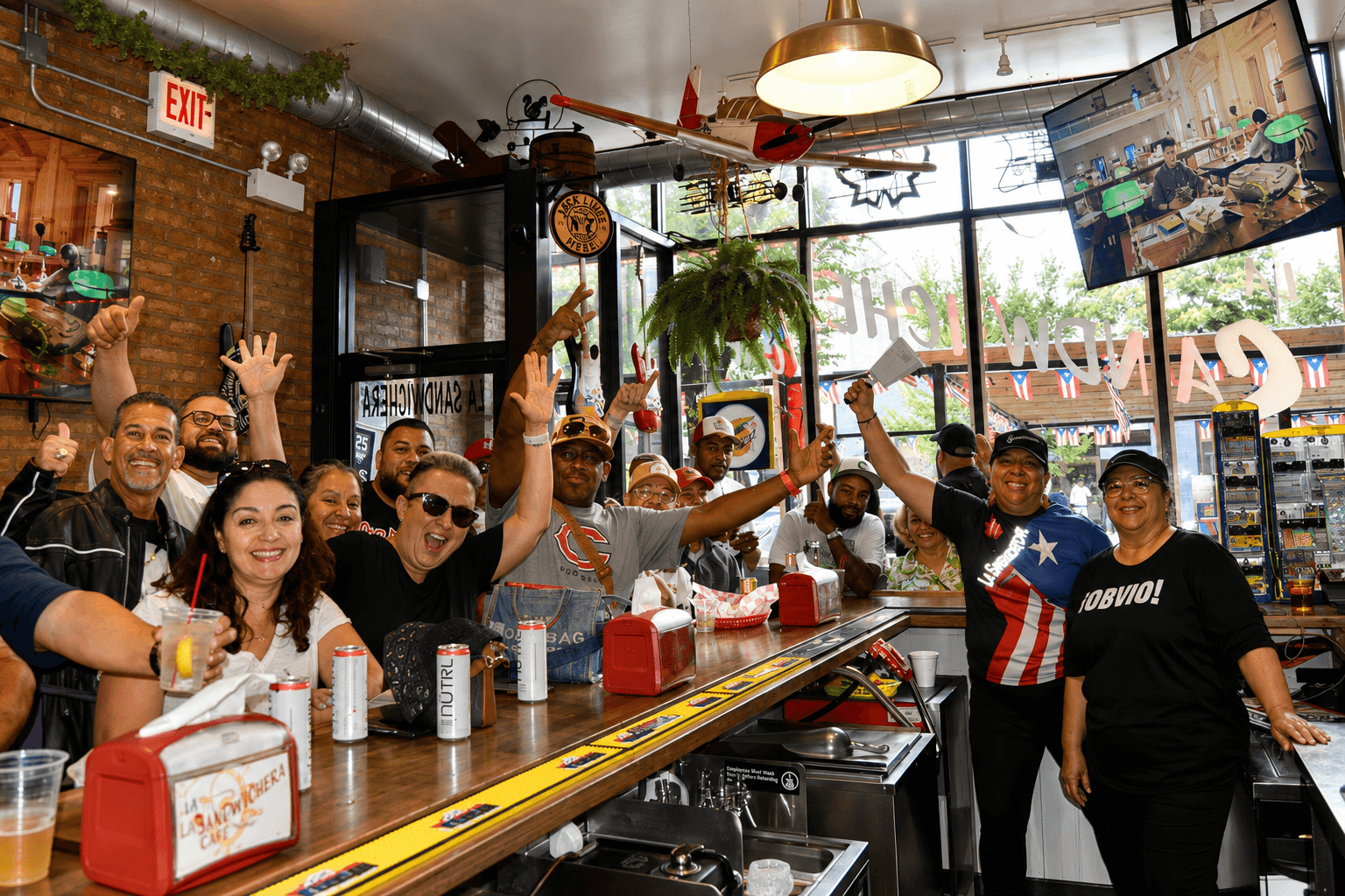 Guests cheering together inside La Sandwichera Cafe